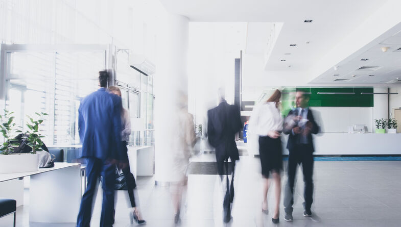 People in motion in office lobby