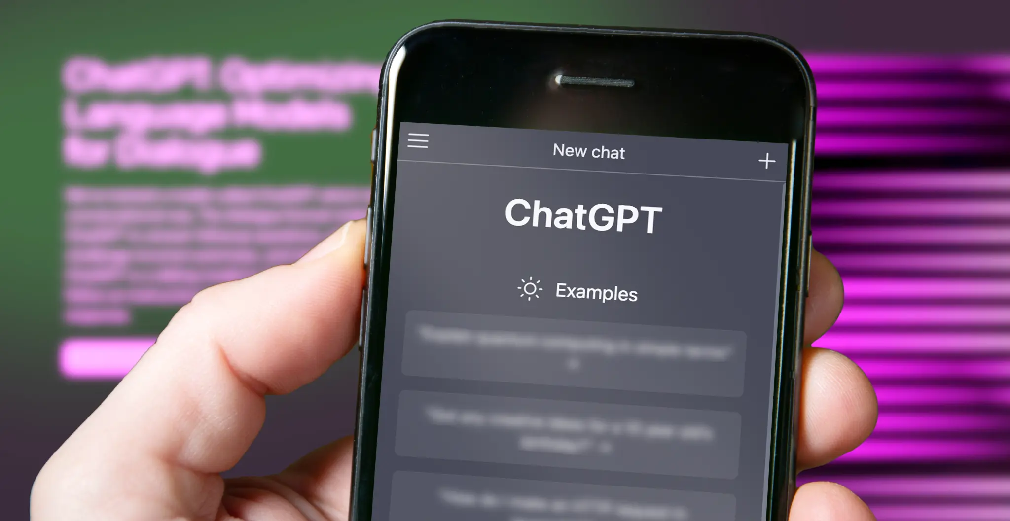 A close-up photo of a hand holding a smartphone displaying the ChatGPT mobile app on the screen.