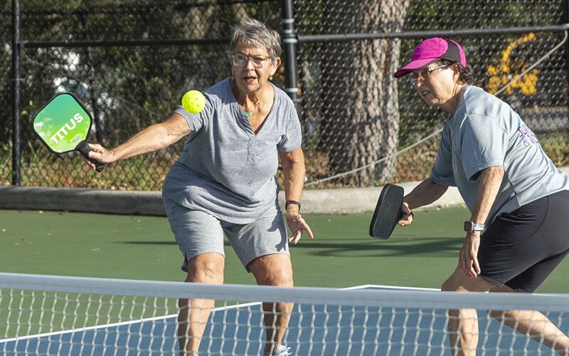 Jackie Rowe and Maria Chambers play a game of pickleball at the Greater Palm Harbor YMCA. Both women participated in Project Rally, which invited cancer survivors and family or friends to pick up the sport as a source of physical activity.