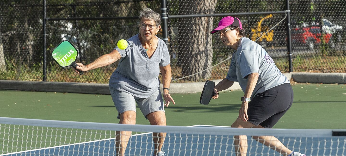 Jackie Rowe and Maria Chambers play a game of pickleball at the Greater Palm Harbor YMCA. Both women participated in Project Rally, which invited cancer survivors and family or friends to pick up the sport as a source of physical activity.