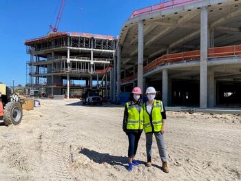 During construction, Christine Alvero wore her pink hard hat on site. She is pictured next to Liz Durrence.