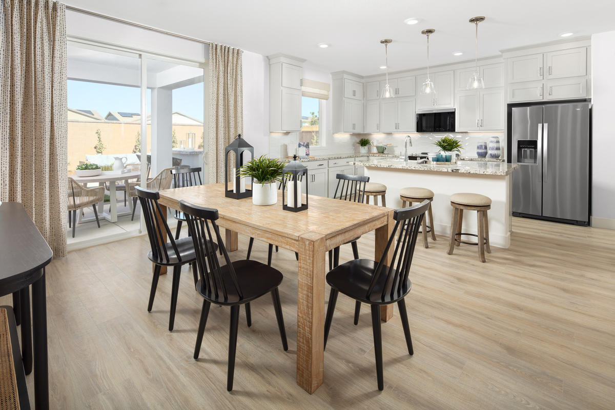 dining room with wood table, and six black chairs