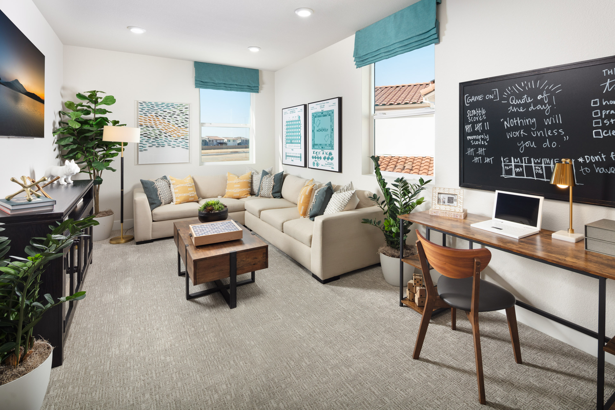 loft with sectional, desk, and chalkboard