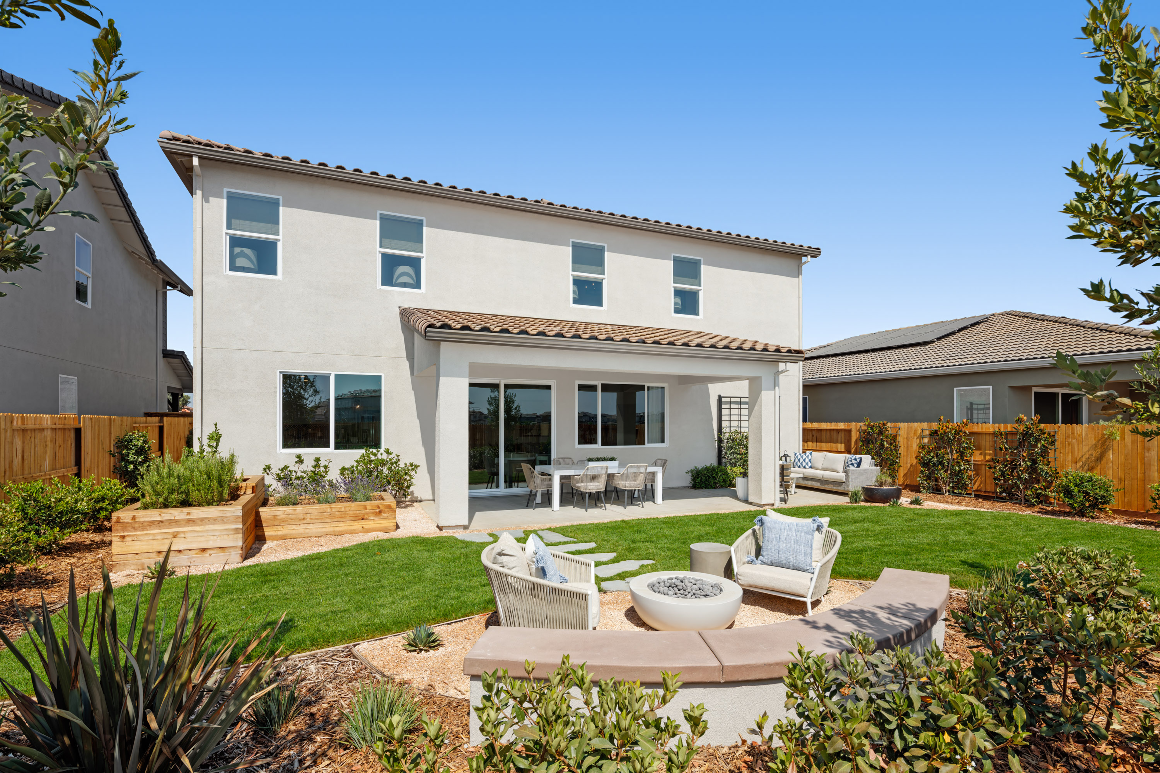 backyard with fire pit, and garden beds