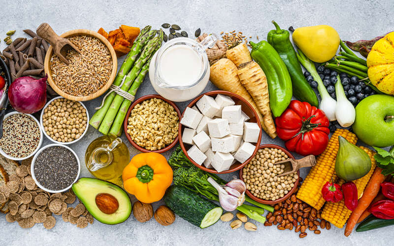 Overhead view of healthy organic fruits, vegetables and soy products.