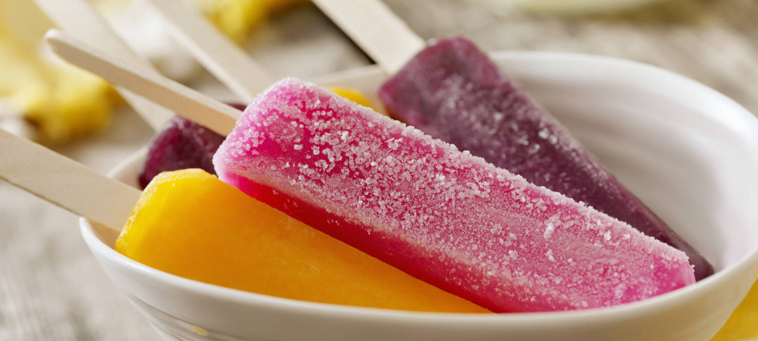 cherry, grape and orange popsicles at a picnic 
