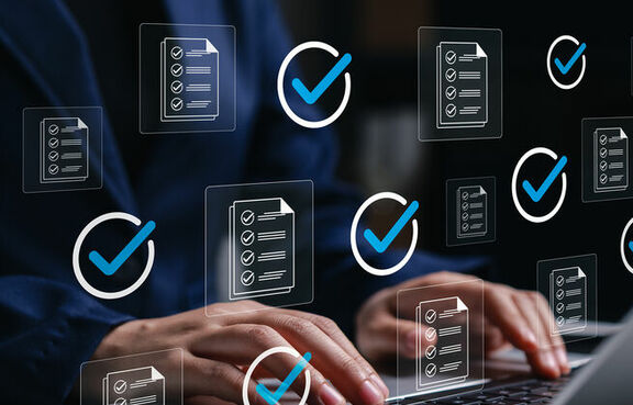 Professional using laptop with approved files check marks
