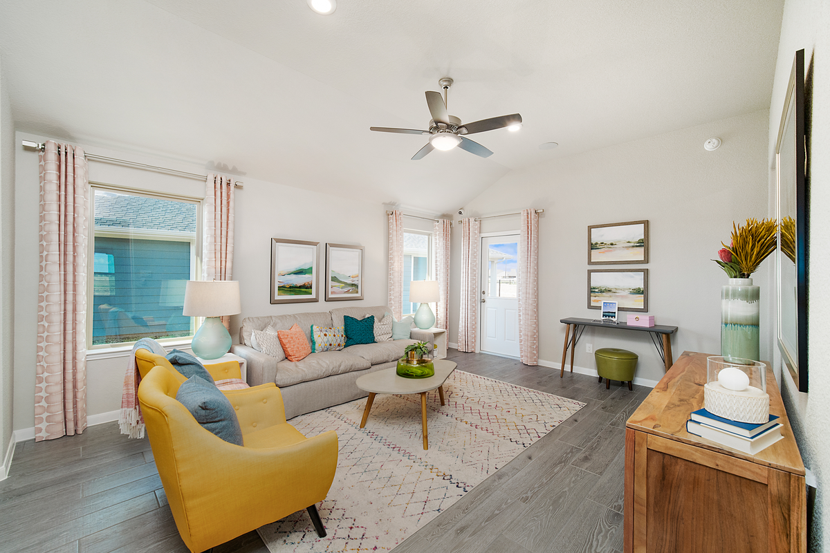 great room with rug and yellow accent chairs