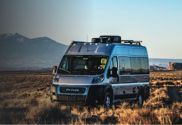 Small motorhome with onboard Fathom e-power system parked on a prairie at sunset