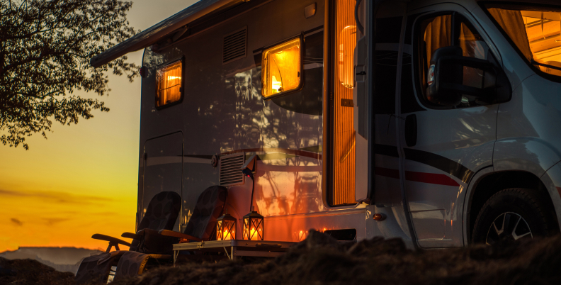 RV after sunset with interior lights blazing