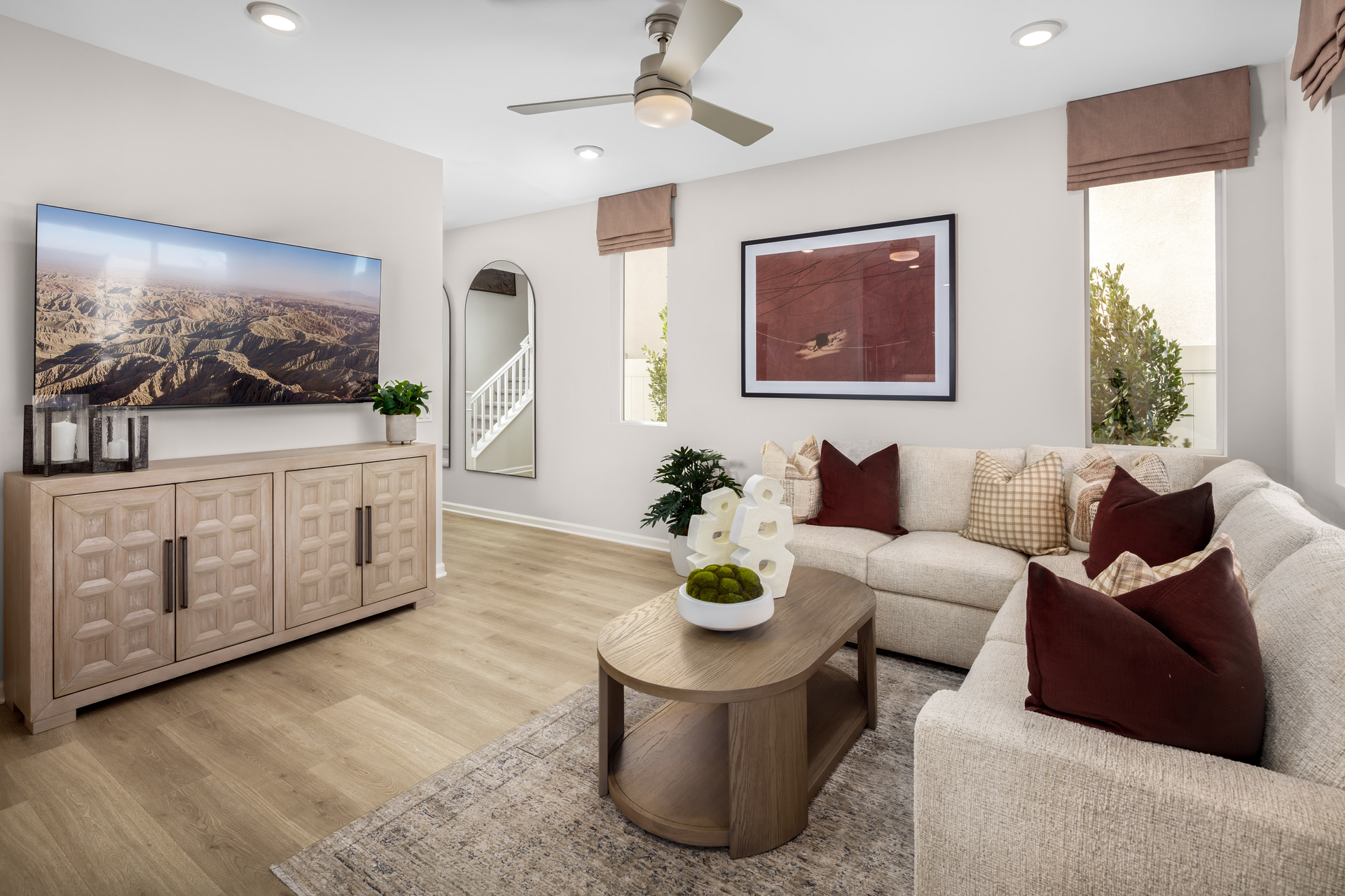 great room with neutral floors and large windows