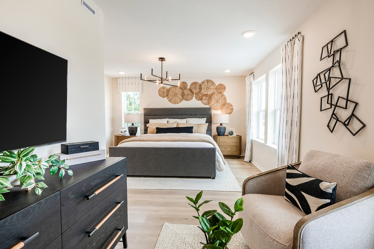 primary bedroom with gray bed and two nightstands