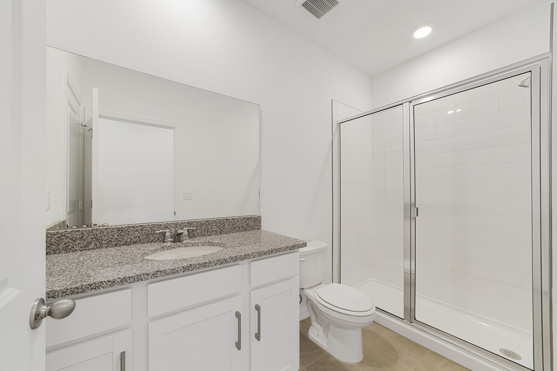 single sink vanity, water closet and shower