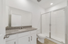 single sink vanity, water closet and shower
