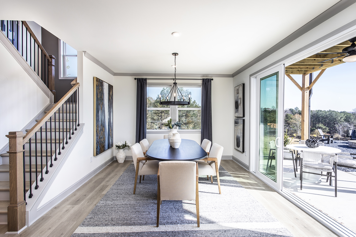 dining room with plank floors and stairs
