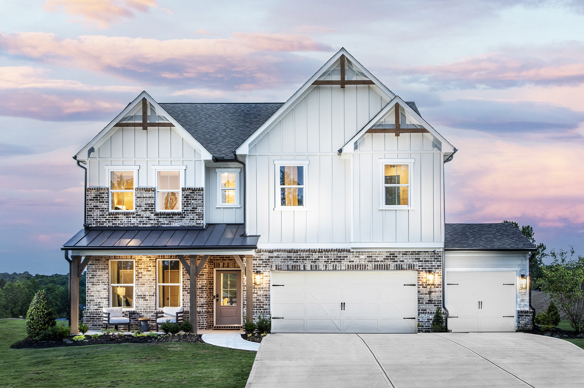 front of 2-story home with white siding and brick