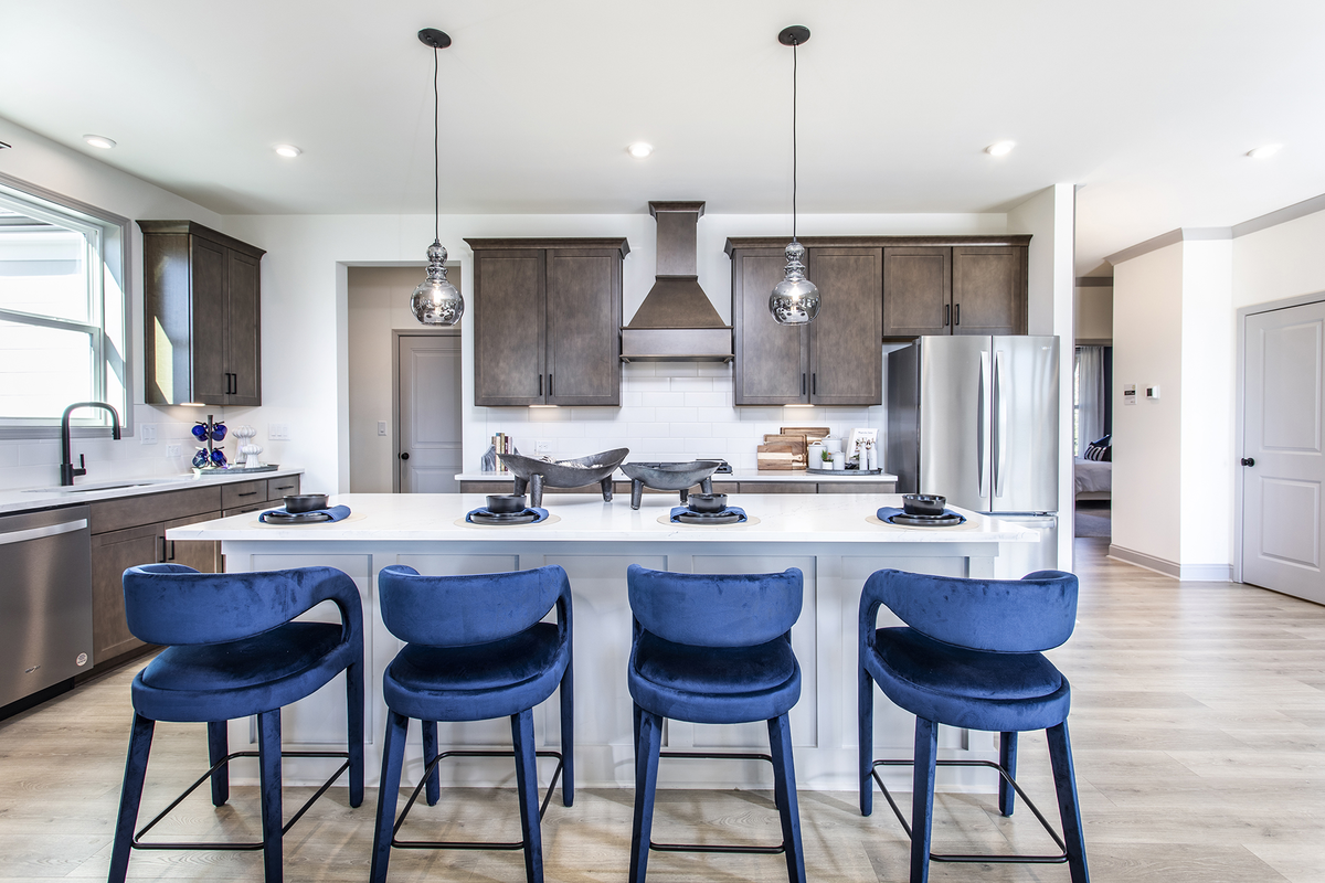 kitchen with brown cabinets & quartz counters