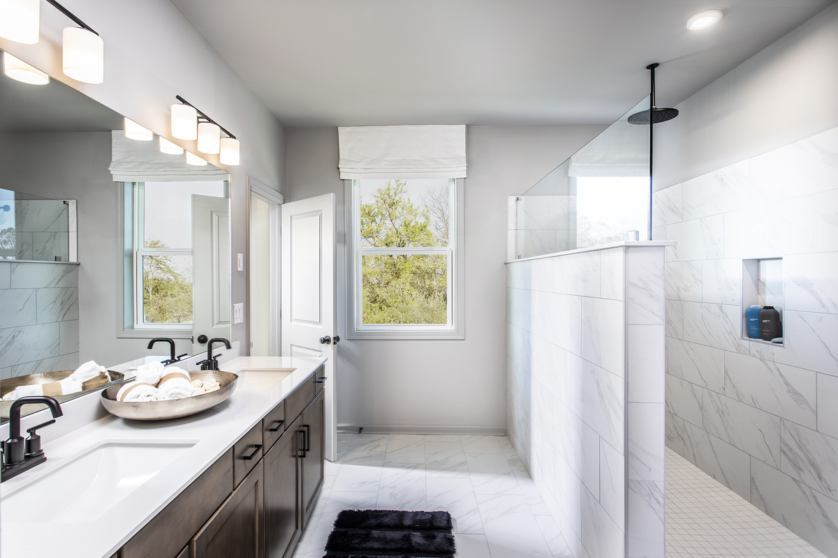primary bathroom with walk-in shower & dual vanity