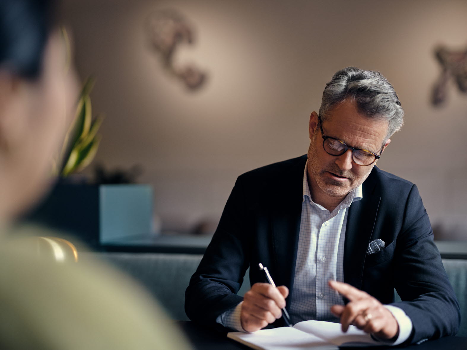Man sitting at a desk writing