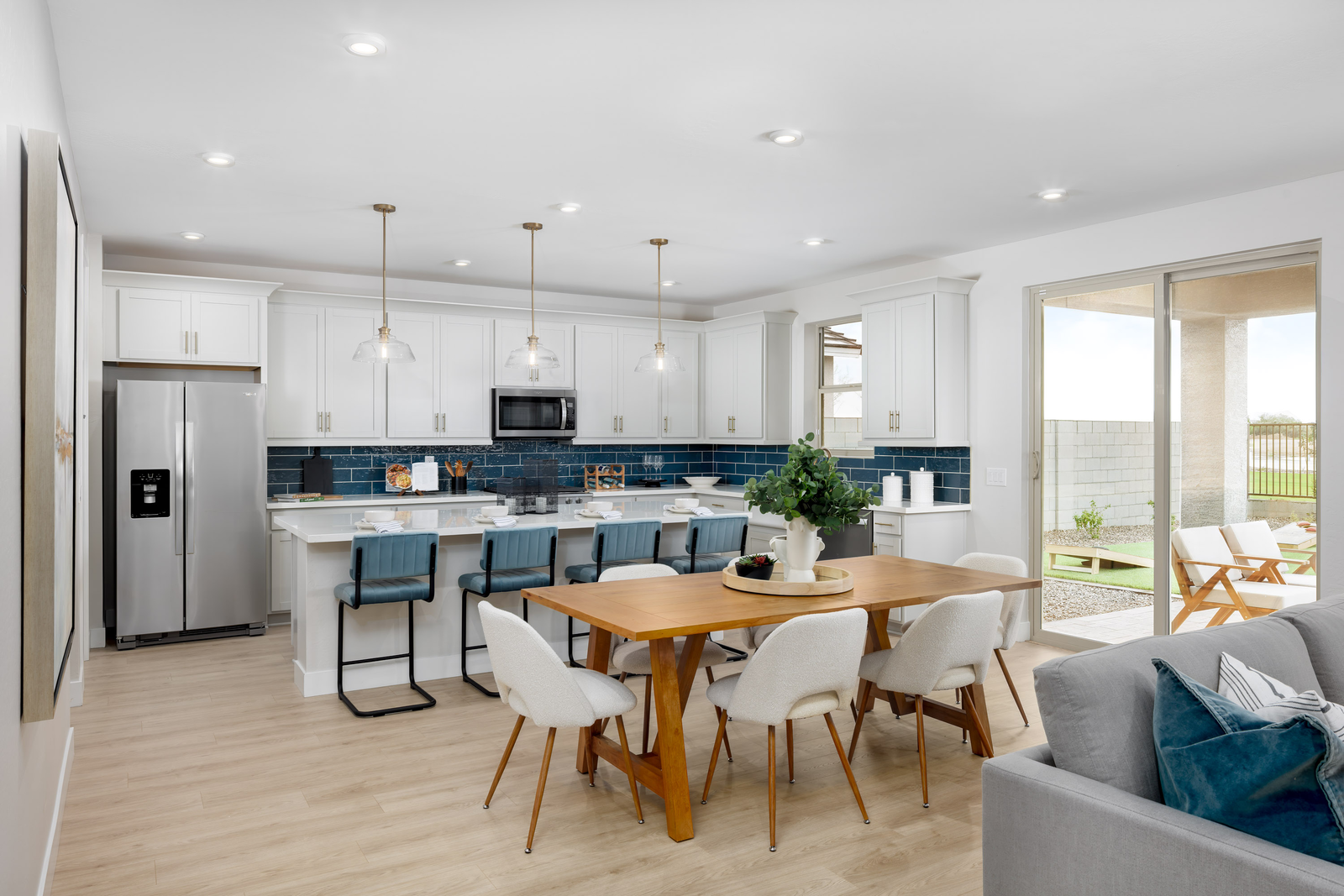 open-concept space with another dining table and wood like flooring