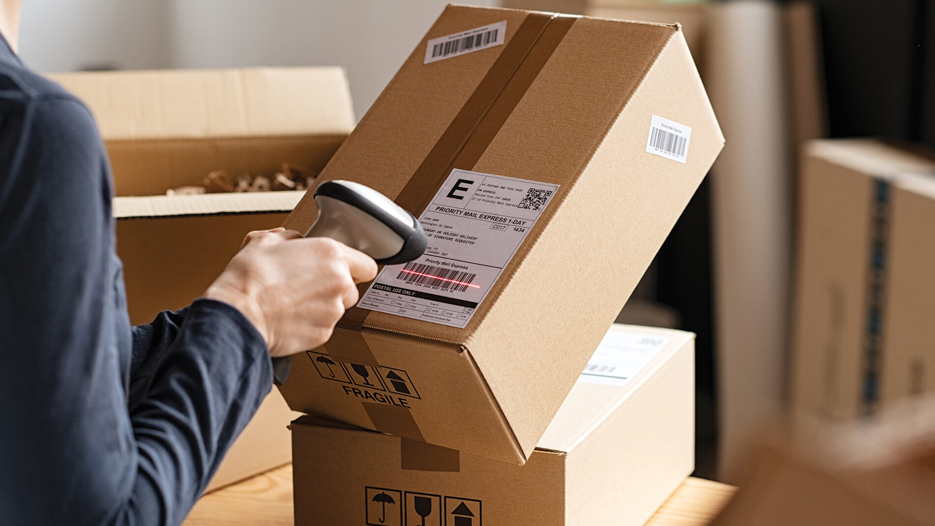 SeamlessExperience.jpg Image of a person scanning the barcode on a package.