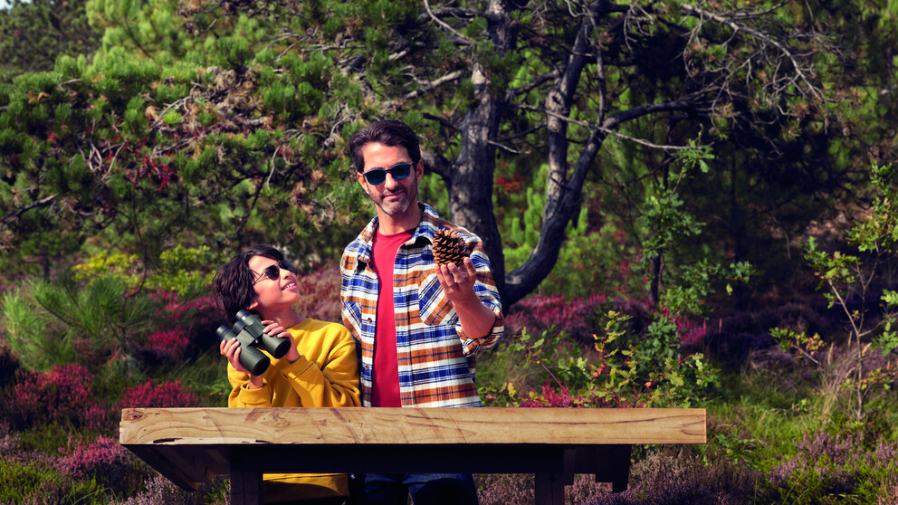 Boy and father looking at birds outdoors while wearing HOYA Sensity 2 sunglasses