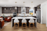 kitchen with wood floors, espresso cabinets, white counters, three barstools at island, and window