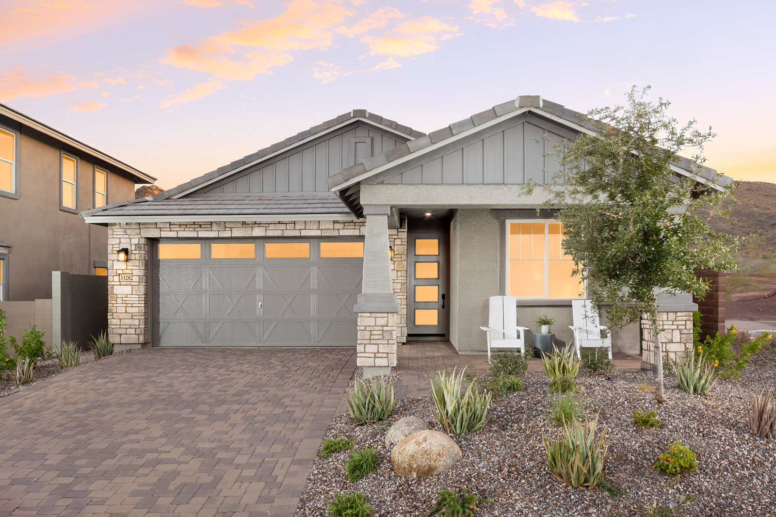stucco home with paved driveway