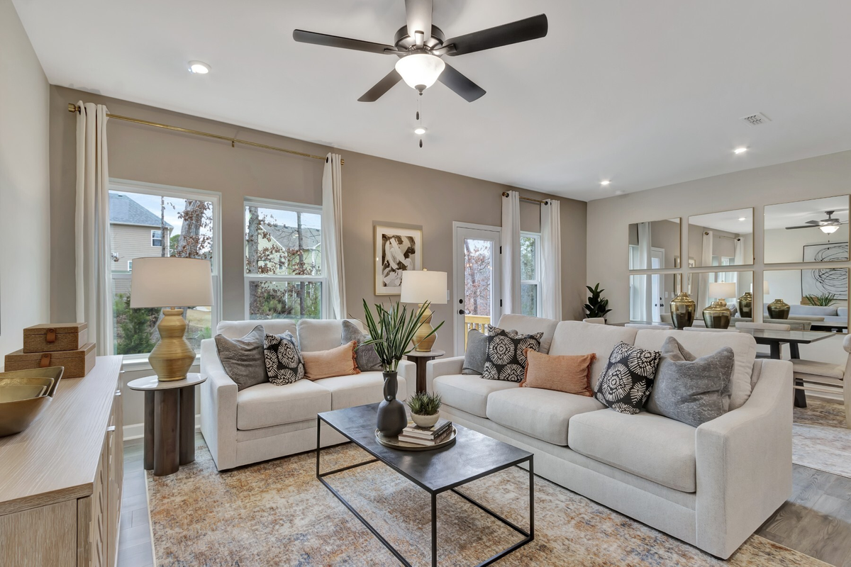 room with two couches and wood floors