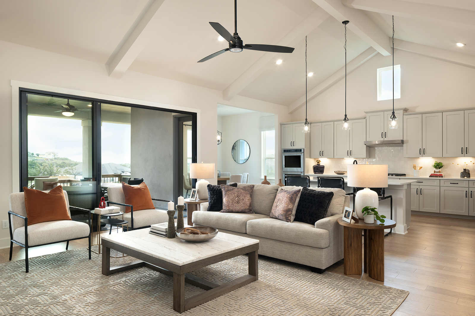 great room with couch, rug & large windows