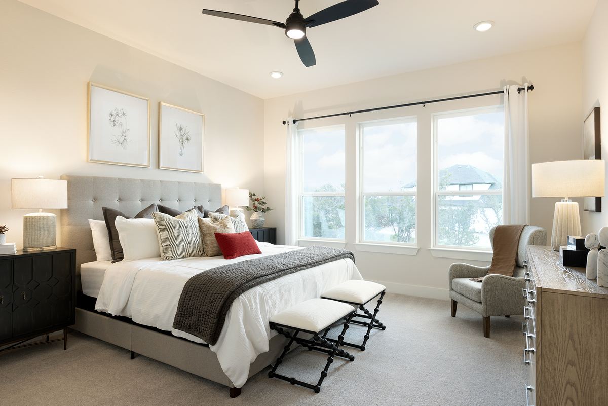bedroom with carpet, windows, bed & nightstands 