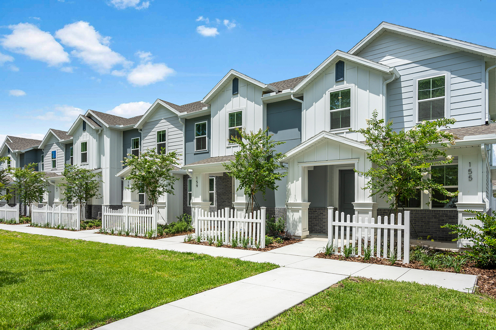 exterior of townhome building with white fence