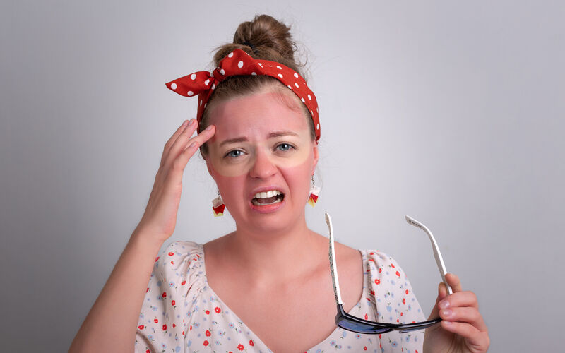 Young caucasian woman girl with red sunglasses sunburn on her face