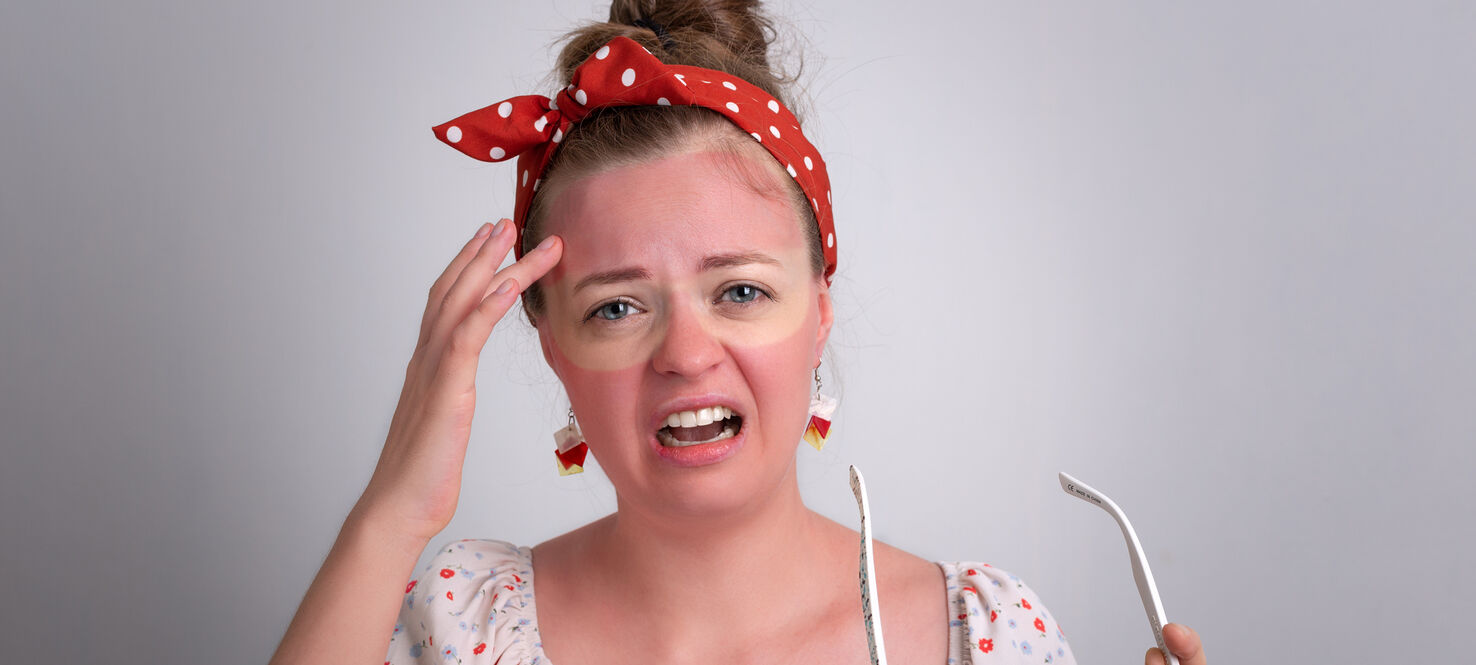 Young caucasian woman girl with red sunglasses sunburn on her face