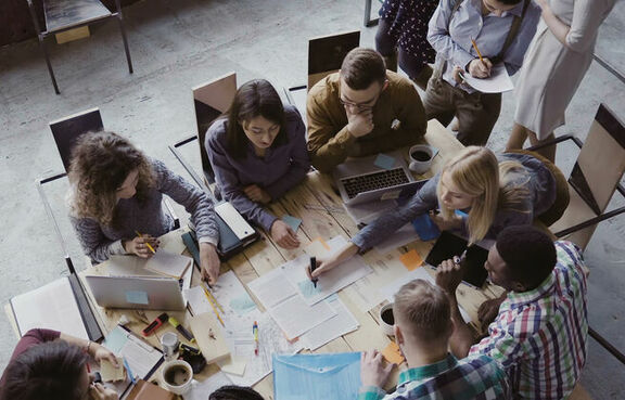 Team of coworkers working together at a conference table