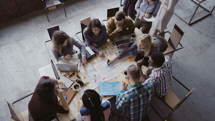 Team of coworkers working together at a conference table