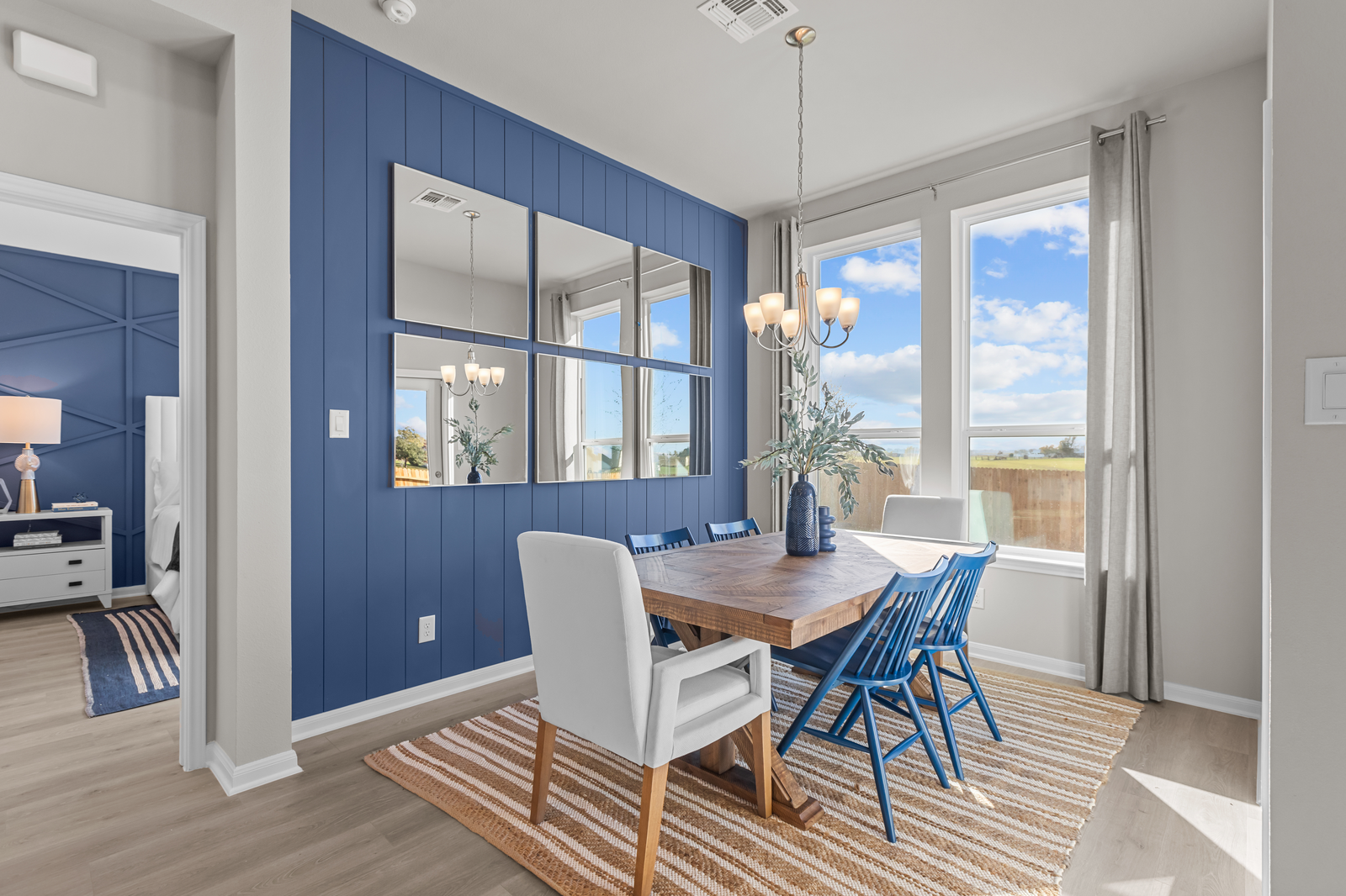 dining area with chandelier & blue accent wall