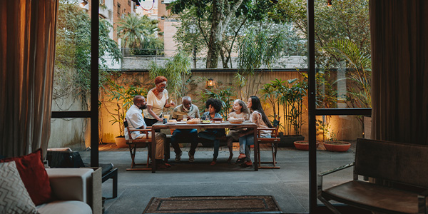An extended family eating on an outdoor patio.