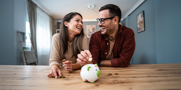 A smiling couple saving money