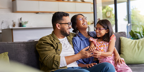 A happy family sitting together on the couch