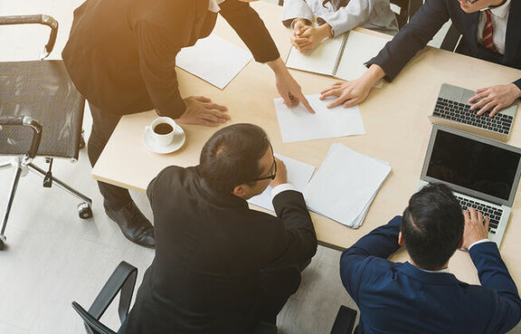 Business people at a conference table looking at documents