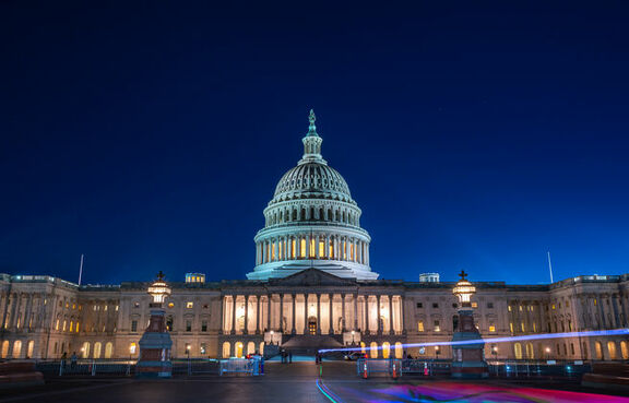 U.S. Capitol Building at night with motion blurred traffic 