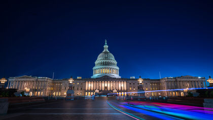 U.S. Capitol Building at night with motion blurred traffic 
