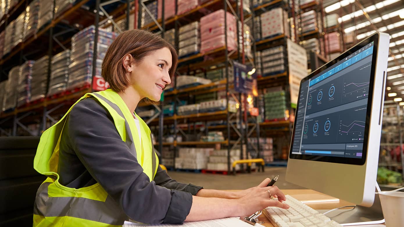 Female worker looking at a computer in a warehouse