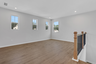 loft with hard surface flooring and windows