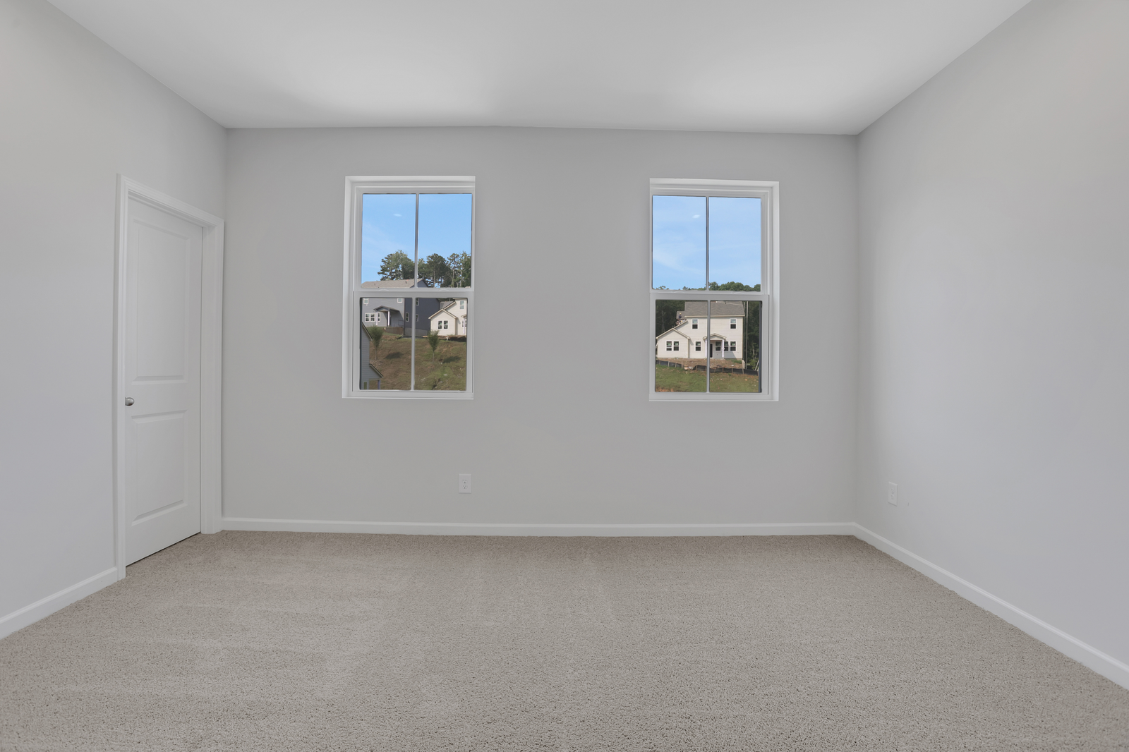 secondary bedroom with windows and carpet