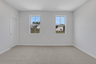 secondary bedroom with windows and carpet