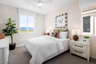bedroom with neutral carpet and large window