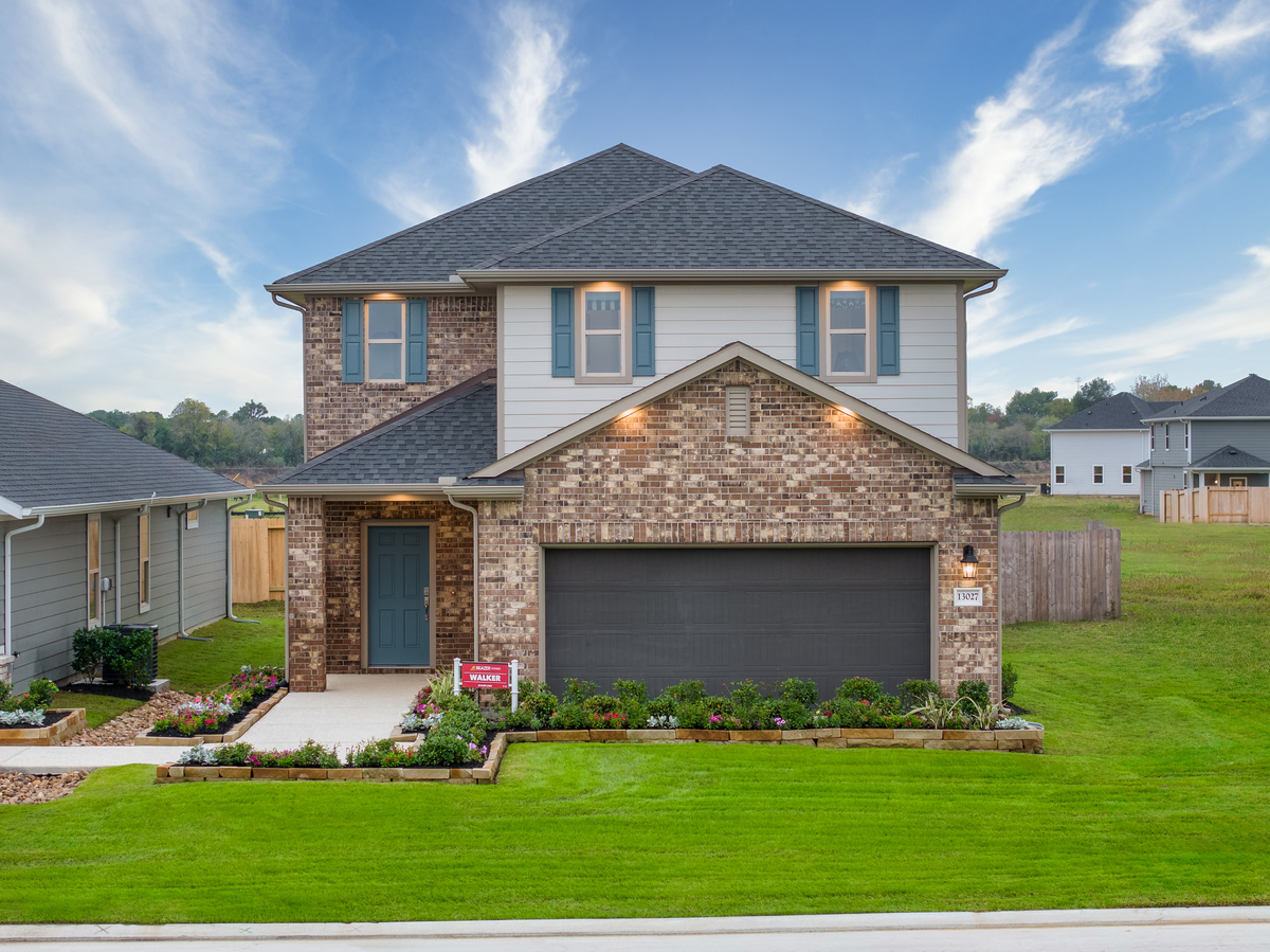 home exterior with garage and landscaping