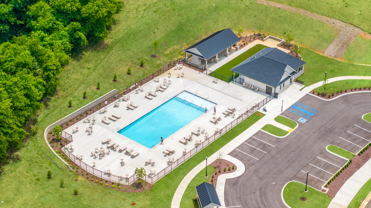 amenities with pool, clubhouse, and green space